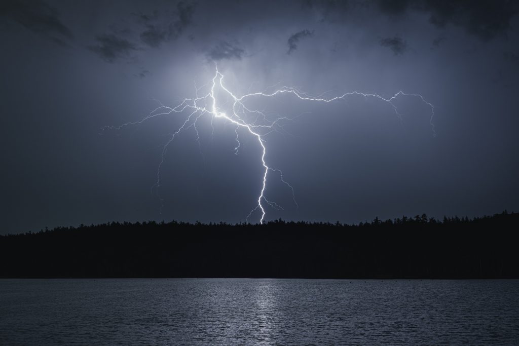 Lightning striking a lake.
